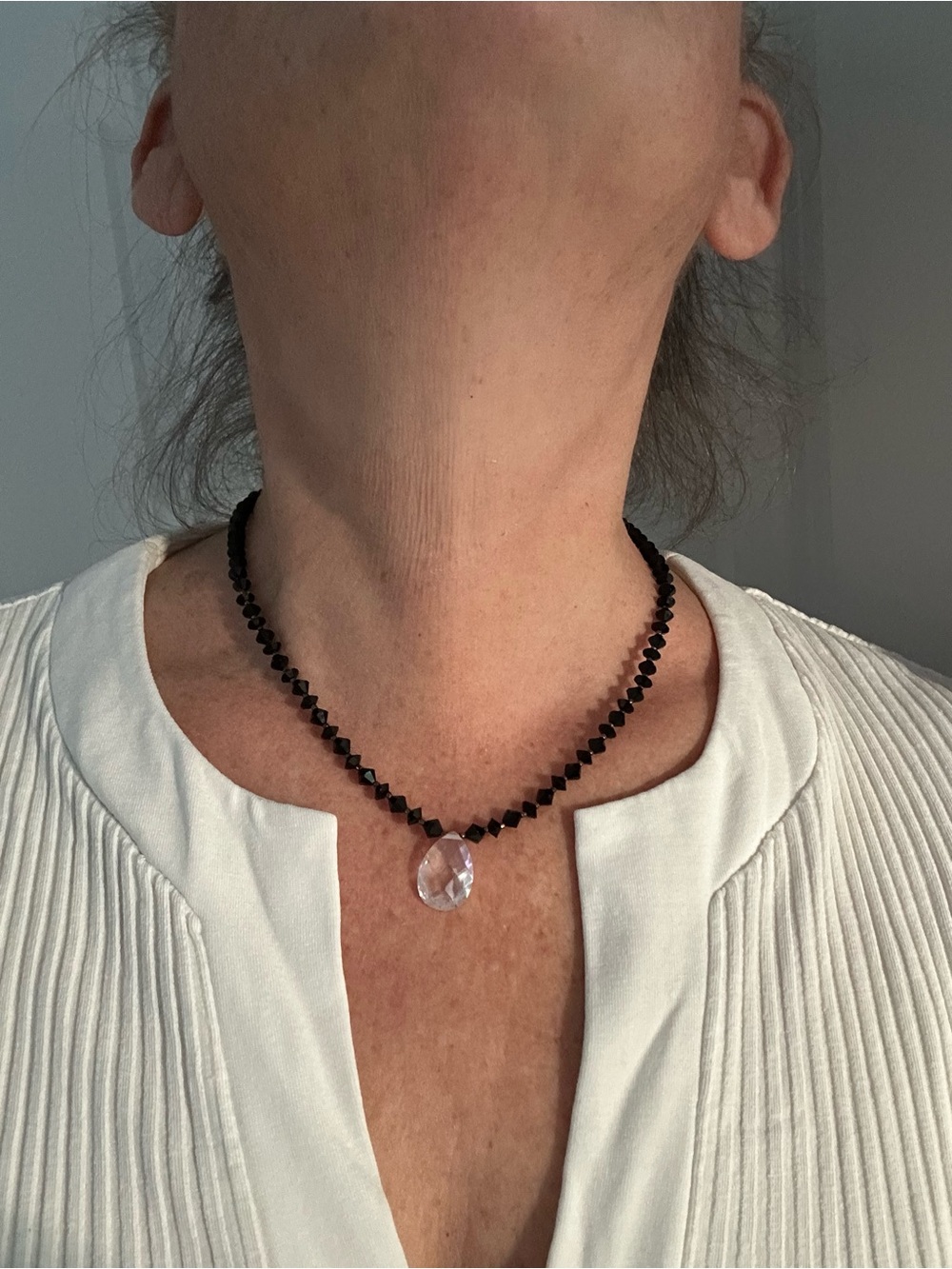 Faceted Black Bead Necklace with Clear Teardrop Pendant